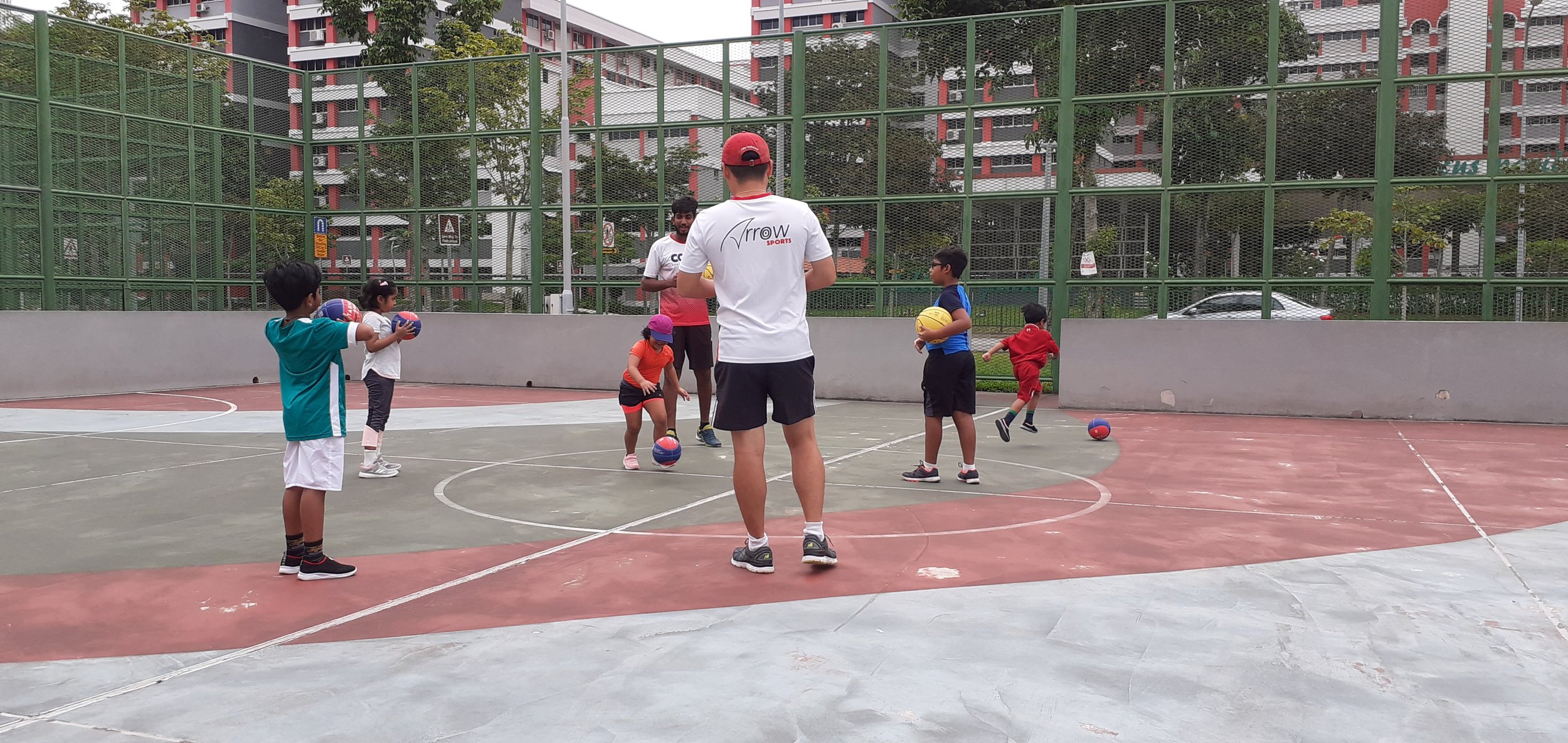 Kids playing multisports in Hougang Singapore. Multi sports classes for kids to develop basic movement skills. Children can learn to play different sports like cricket, basketball, tennis, and rugby in multi sports lessons across SG.